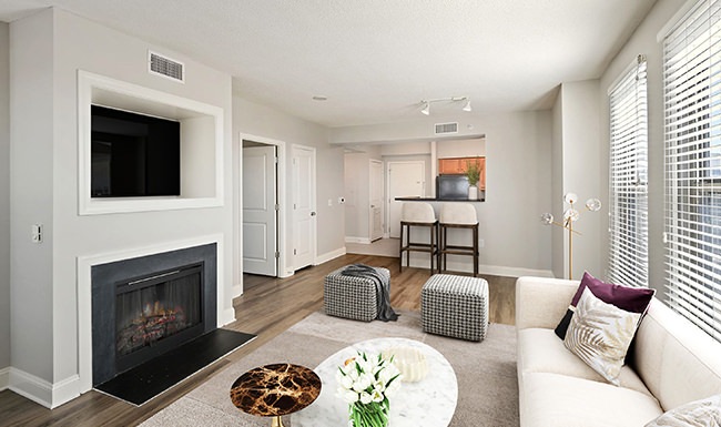 furnished living room with fireplace and white walls